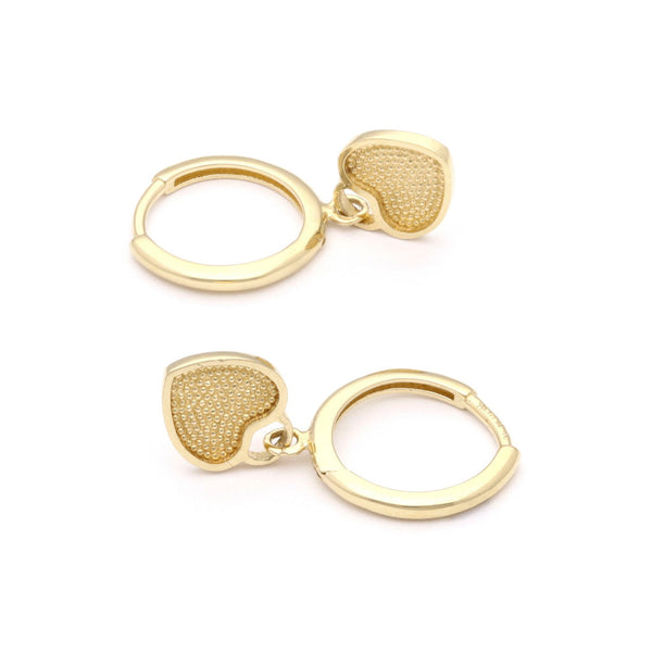 Arracadas articuladas con colgante motivo corazón en oro amarillo 14 kilates.