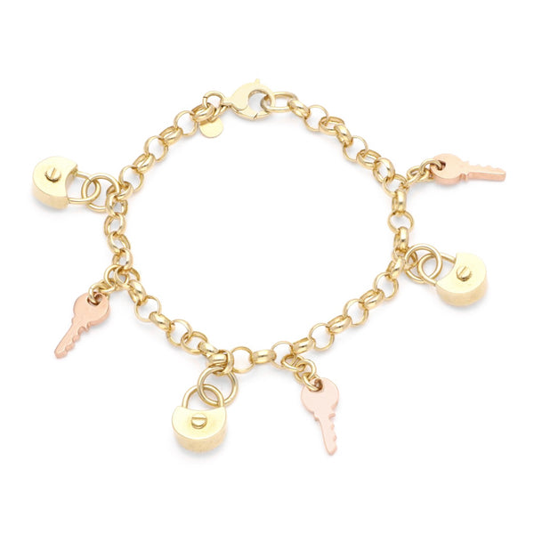 Pulsera eslabón cruzado con colgantes motivos candado y llave en oro dos tonos 14 kilates.