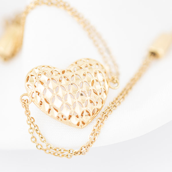 Pulsera de dos hilos eslabón cruzado con aplicación motivo corazón en oro amarillo 14 kilates.