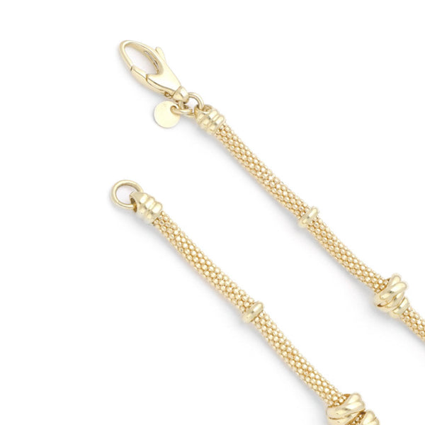 Pulsera eslabón tejido con aplicaciones en oro amarillo 14 kilates.