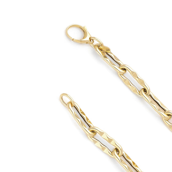 Pulsera eslabón cruzado facetado en oro amarillo 14 kilates.