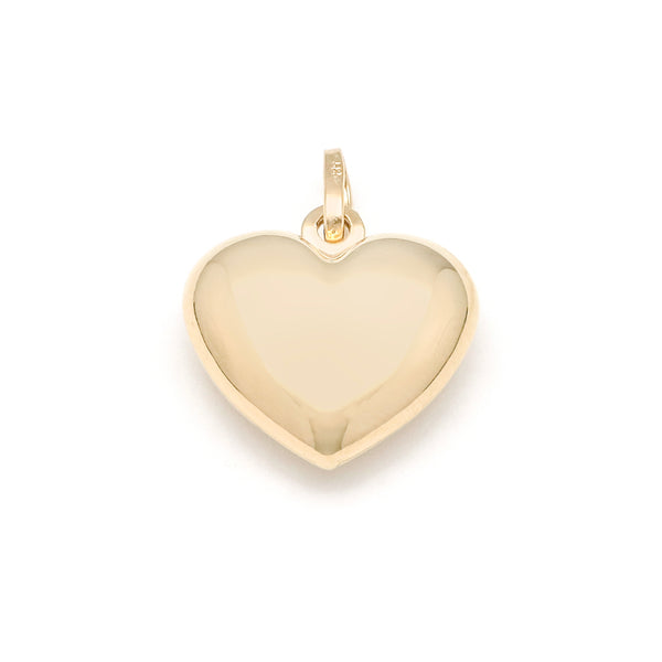 Dije hueco motivo corazón en oro amarillo 14 kilates.