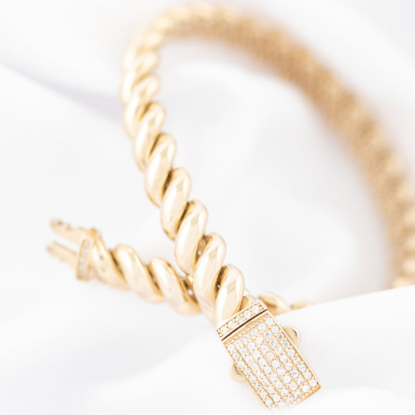 Pulsera eslabón articulado con circonias en oro amarillo 14 kilates.