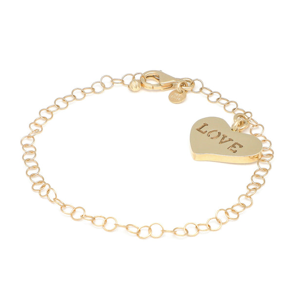 Pulsera eslabón cruzado con colgante motivo corazón en oro amarillo 14 kilates.