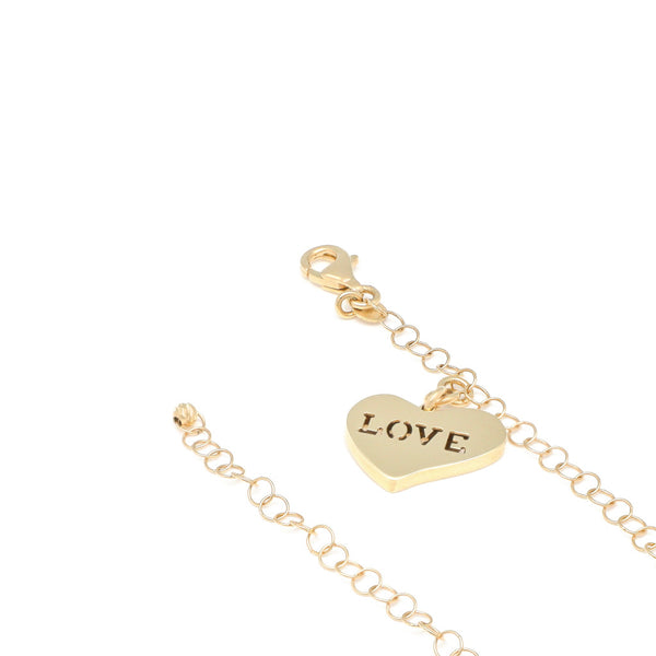 Pulsera eslabón cruzado con colgante motivo corazón en oro amarillo 14 kilates.