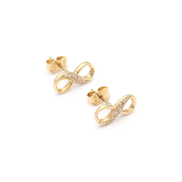 Aretes diseño especial con circonias motivo infinito en oro amarillo 14 kilates.
