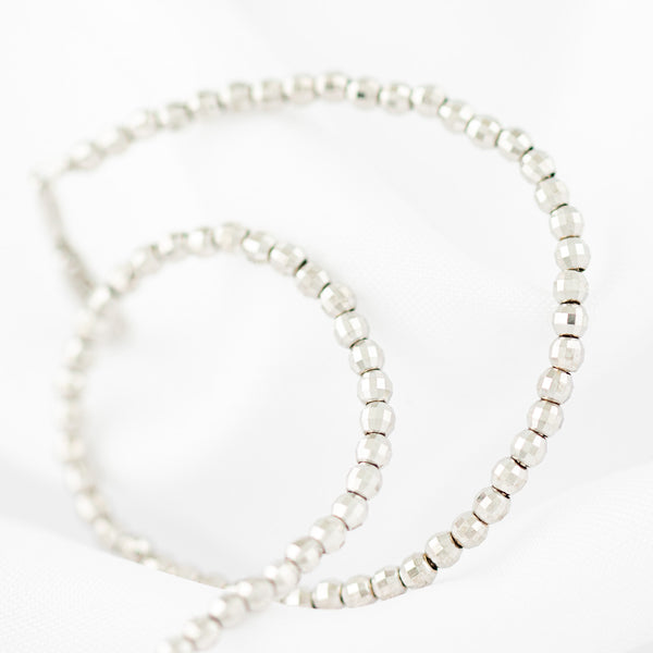 Pulsera eslabón boleado en oro blanco 14 kilates.