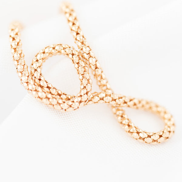 Pulsera eslabón tejido en oro rosa 14 kilates.