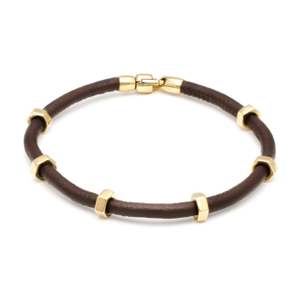 Pulsera de caucho con aplicaciones, casquillo y broche en oro amarillo 14 kilates.