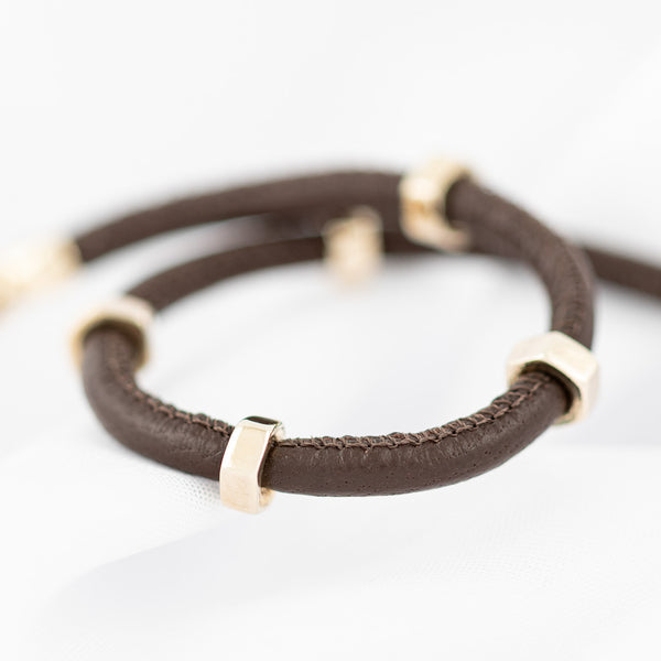 Pulsera de caucho con aplicaciones, casquillo y broche en oro amarillo 14 kilates.