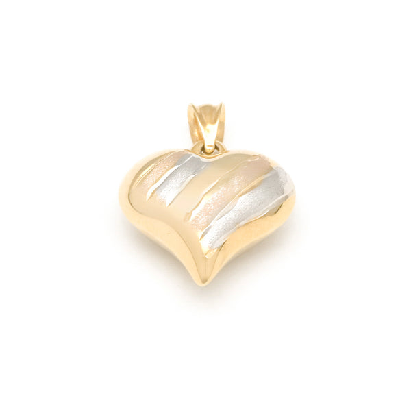 Dije hueco motivo corazón en oro amarillo 14 kilates.
