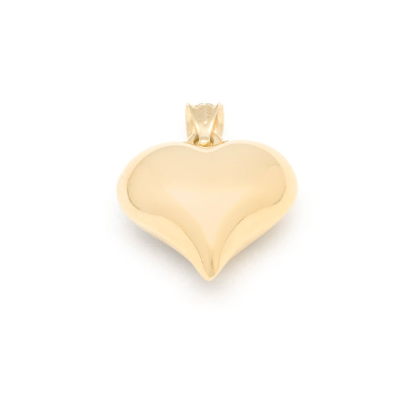 Dije hueco motivo corazón en oro amarillo 14 kilates.