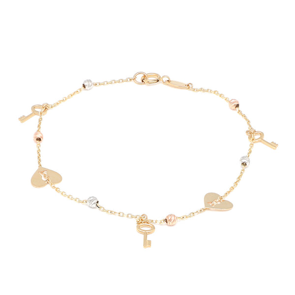 Pulsera eslabón cruzado con aplicaciones y colgantes motivo corazón y llave en oro tres tonos 14 kilates.