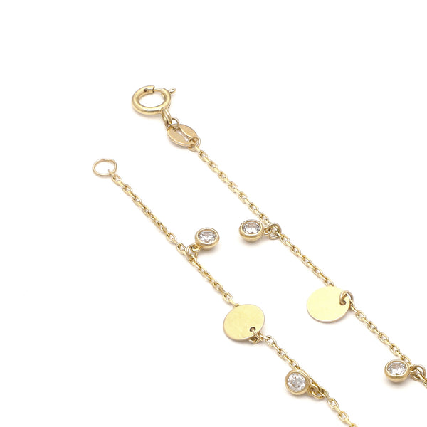 Pulsera eslabón cruzado con colgantes motivo círculos y circonias en oro amarillo 14 kilates.