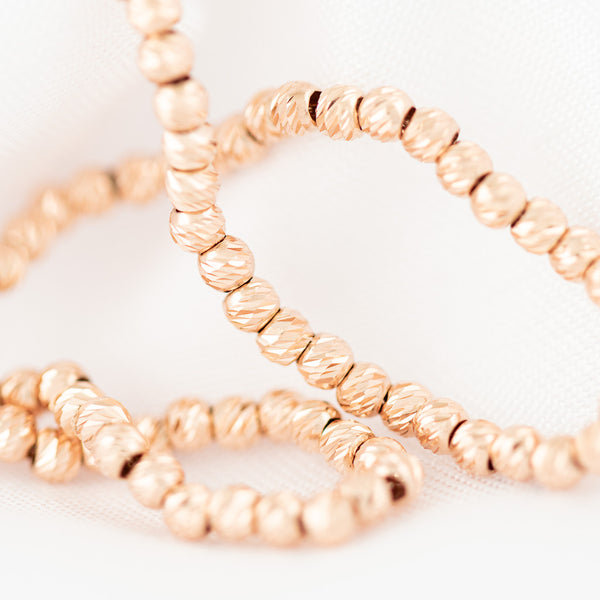 Pulsera eslabón boleado en oro rosa 14 kilates.