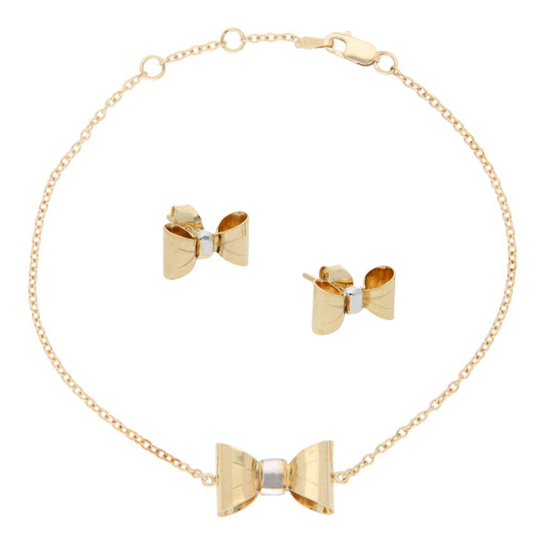 Juego de pulsera eslabón cruzado con aplicación y broqueles diseño especial motivo moño en oro amarillo 14 kilates.