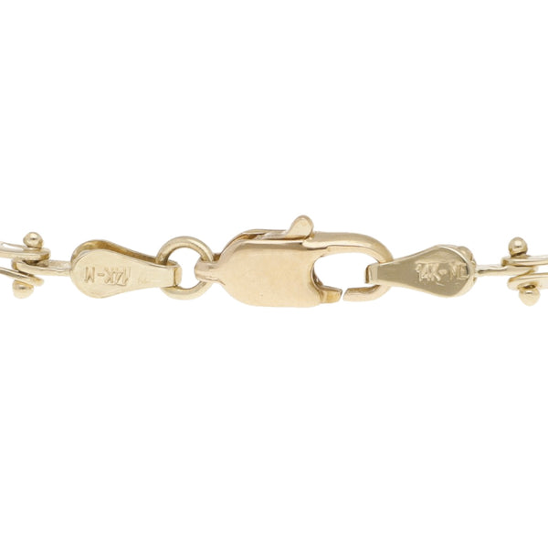 Pulsera eslabón articulado con perlas en oro amarillo 14 kilates.