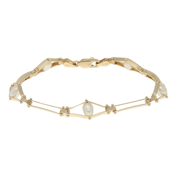 Pulsera eslabón articulado con perlas en oro amarillo 14 kilates.