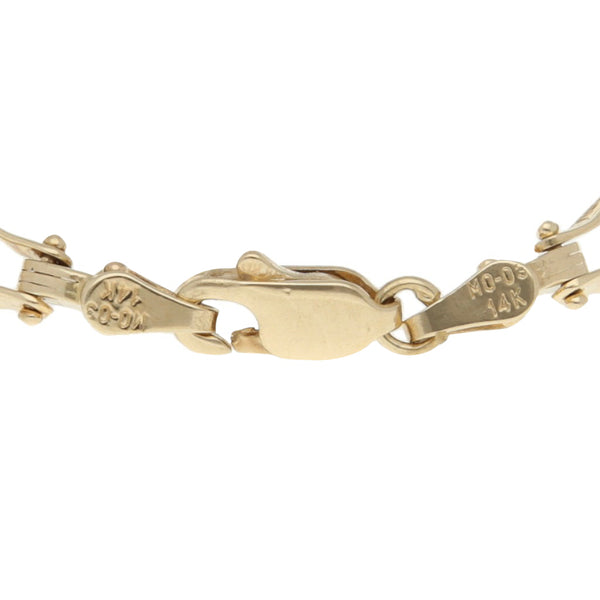 Pulsera eslabón articulado con perlas en oro amarillo 14 kilates.