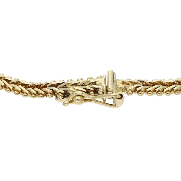 Pulsera eslabón boleado con aplicaciones en oro tres tonos 14 kilates.