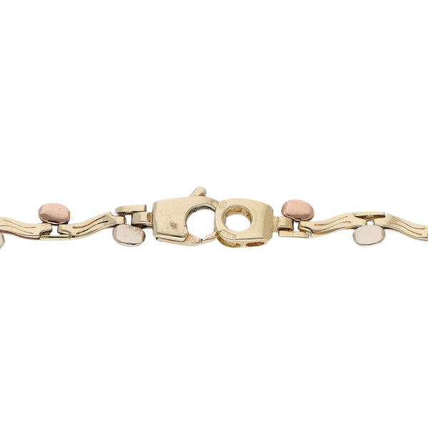 Pulsera eslabón articulado con aplicaciones en oro tres tonos 14 kilates.