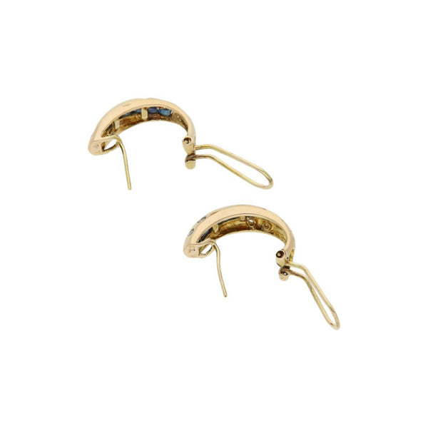 Juego de anillo y aretes estilizados con diamantes y zafiros en oro amarillo 14 kilates.