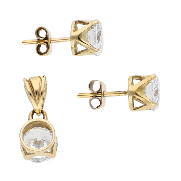 Juego de aretes y dije diseño especial con circonias en oro amarillo 14 kilates.