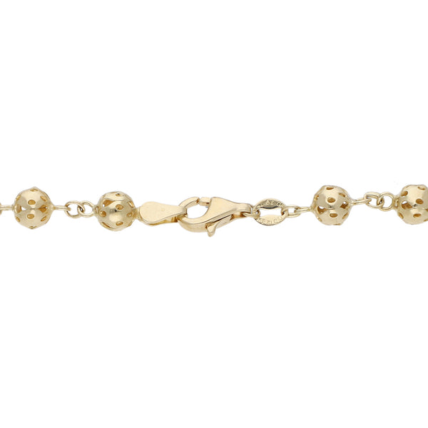 Pulsera tipo rosario eslabón cruzado con cuentas caladas en oro amarillo 14 kilates.
