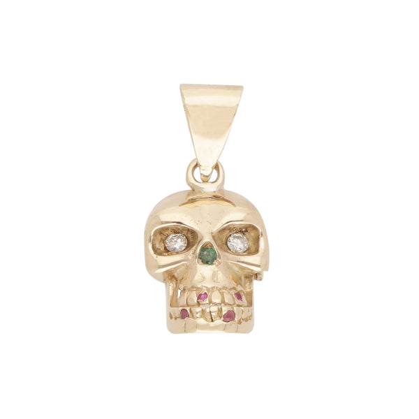 Dije diseño especial motivo calavera con diamantes, esmeraldas y rubíes en oro amarillo 14 kilates.
