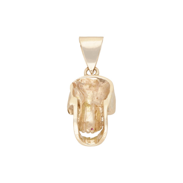Dije diseño especial motivo calavera con diamantes, esmeraldas y rubíes en oro amarillo 14 kilates.
