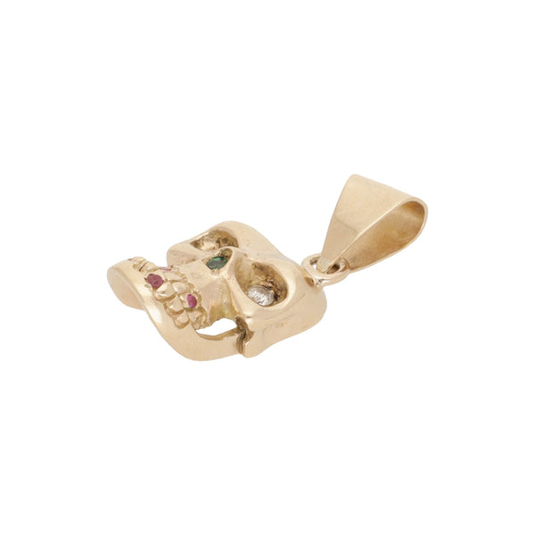 Dije diseño especial motivo calavera con diamantes, esmeraldas y rubíes en oro amarillo 14 kilates.