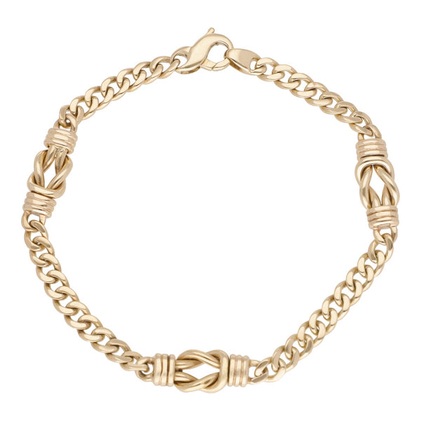 Pulsera eslabón encontrado con aplicación motivo nudo en oro amarillo 14 kilates.