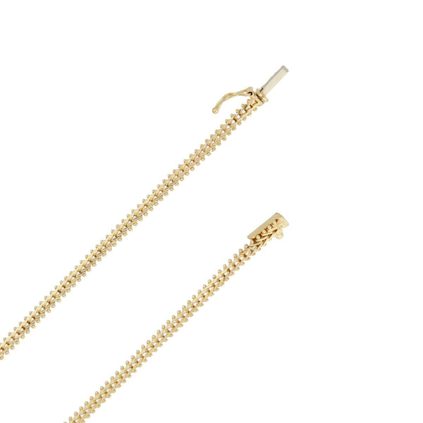 Gargantilla eslabón boleado con aplicaciones motivo barras en oro tres tonos 14 kilates.