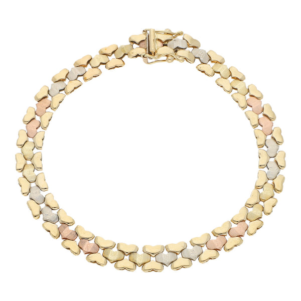 Pulsera eslabón articulado en oro tres tonos 14 kilates.