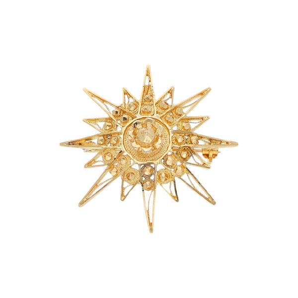 Prendedor diseño especial motivo estrella en oro amarillo 18 kilates.