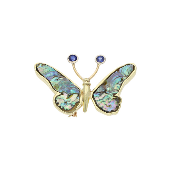 Prendedor diseño especial con madre perla y sintéticos motivo mariposa en oro amarillo 14 kilates