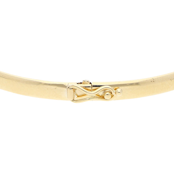 Pulsera de arillo articulada con aplicación motivo pantera en oro amarillo 14 kilates.