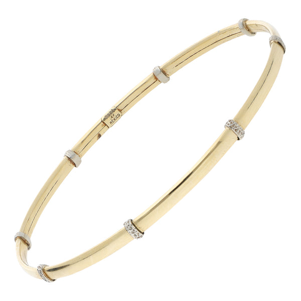 Pulsera de arillo lisa con aplicaciones en oro dos tonos 14 kilates.