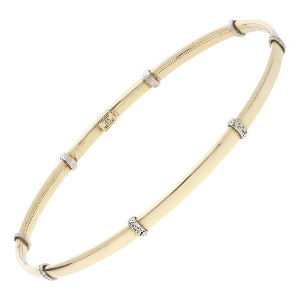 Pulsera de arillo lisa con aplicaciones en oro dos tonos 14 kilates.