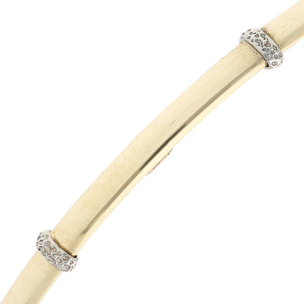 Pulsera de arillo lisa con aplicaciones en oro dos tonos 14 kilates.