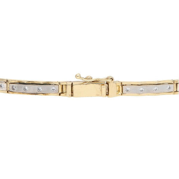 Pulsera eslabón articulado con circonias en oro dos tonos 14 kilates.