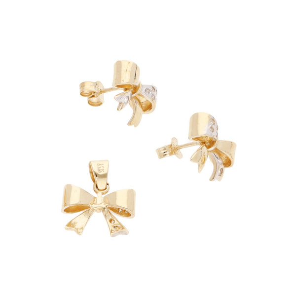 Juego de dije y aretes diseño especial con circonias motivo moño en oro amarillo 14 kilates.