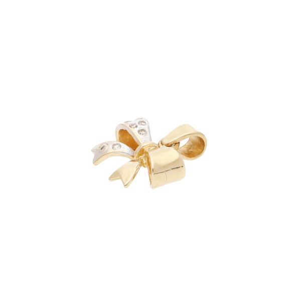 Juego de dije y aretes diseño especial con circonias motivo moño en oro amarillo 14 kilates.
