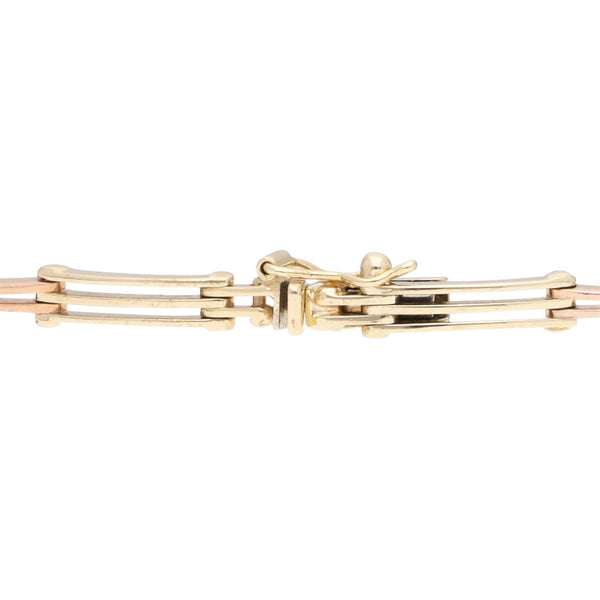 Pulsera eslabón articulado en oro tres tonos 14 kilates.