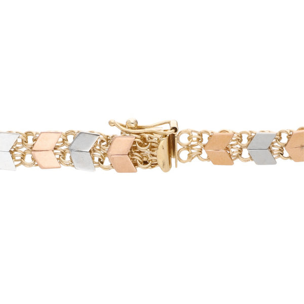 Pulsera eslabón tejido con aplicaciones en oro tres tonos 14 kilates.