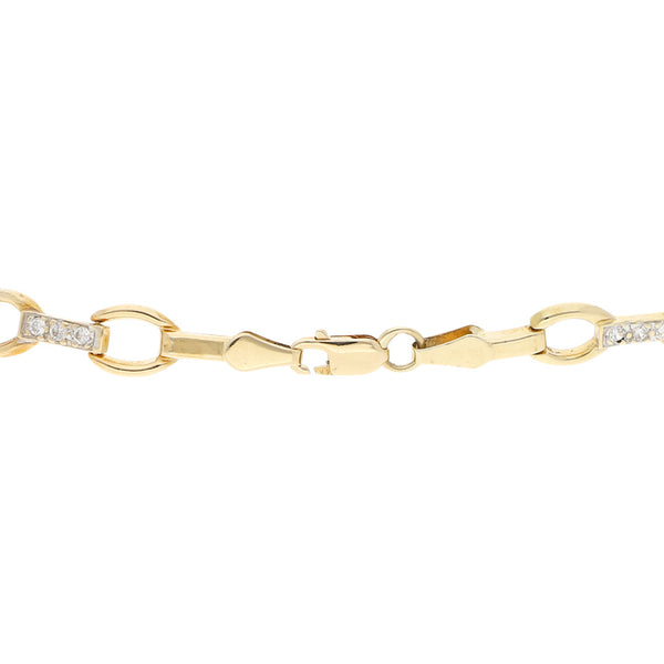 Pulsera eslabón articulado con circonias en oro amarillo 14 kilates.