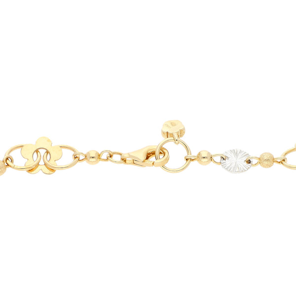 Pulsera eslabón combinado con aplicaciones de flor en oro dos tonos 14 kilates.
