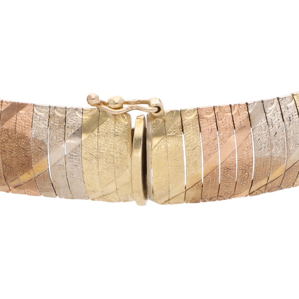 Pulsera eslabón articulado en oro tres tonos 14 kilates.