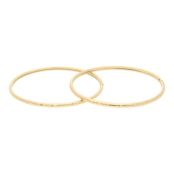 Dos pulseras de arillo labradas en oro amarillo 14 kilates.