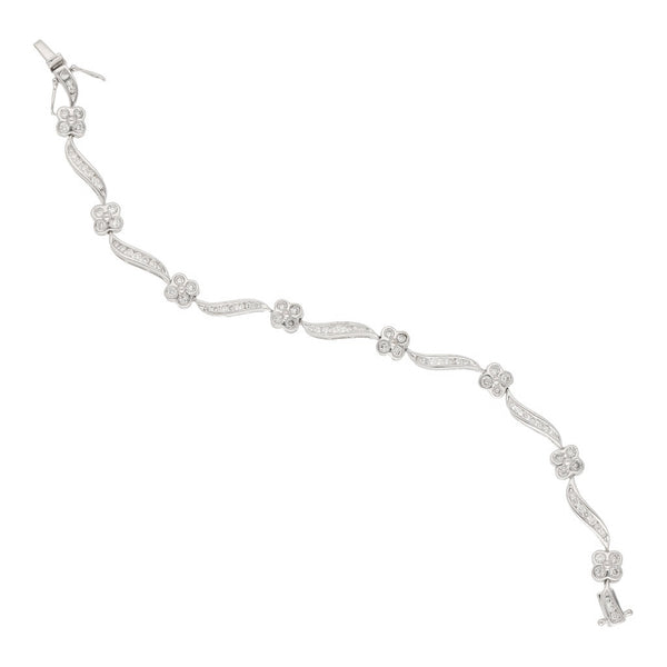 Pulsera eslabón articulado motivo flor con diamantes en oro blanco 14 kilates.